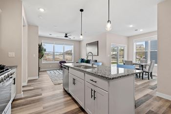 a kitchen with a counter top and a dining room